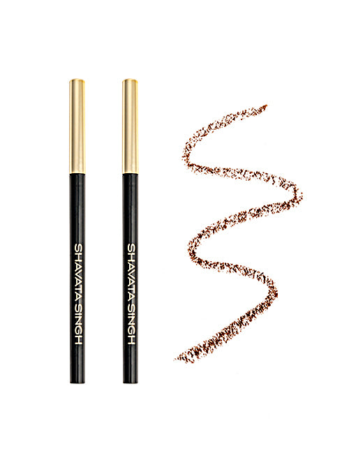 Two eyebrow pencils with a golden cap and a swatch of the brown color they produce on a white background.