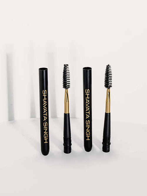 Three lash brushes with black handles and gold accents,